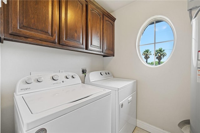 3941 Cobb Ln, Robstown, TX 78380 - laundry area featuring cabinet space, washing machine and dryer, and baseboards