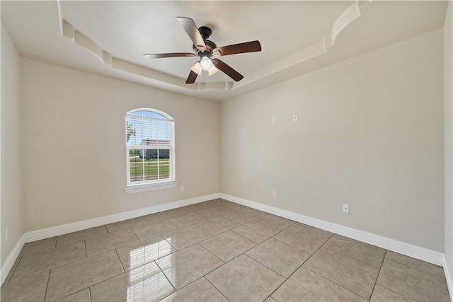 3941 Cobb Ln, Robstown, TX 78380 - tiled empty room featuring a raised ceiling, a ceiling fan, and baseboards