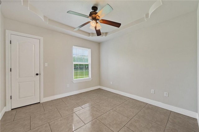 3941 Cobb Ln, Robstown, TX 78380 - unfurnished room with ceiling fan, baseboards, a tray ceiling, and light tile patterned flooring