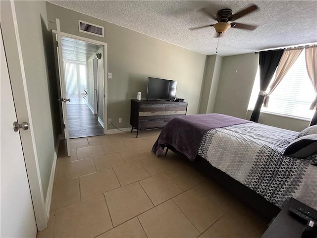 715 S Upper Broadway St Unit 202, Corpus Christi, TX 78401 - bedroom featuring multiple windows, a textured ceiling, light tile patterned flooring, and ceiling fan
