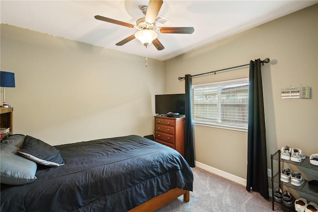 carpeted bedroom featuring baseboards and a ceiling fan