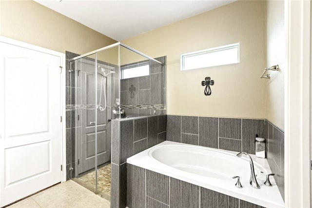 full bath featuring tile patterned floors, a shower stall, and a bath