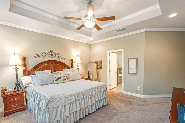 bedroom featuring visible vents, a tray ceiling, and light colored carpet