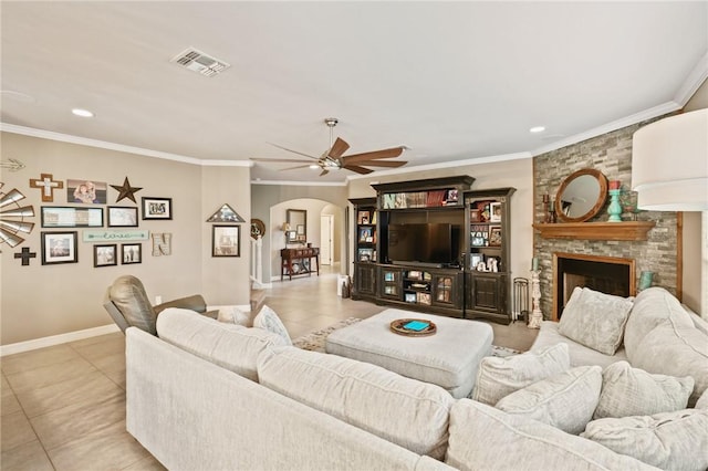 living room with ornamental molding, arched walkways, and visible vents