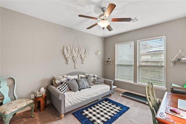 office area featuring a ceiling fan, baseboards, visible vents, and carpet flooring