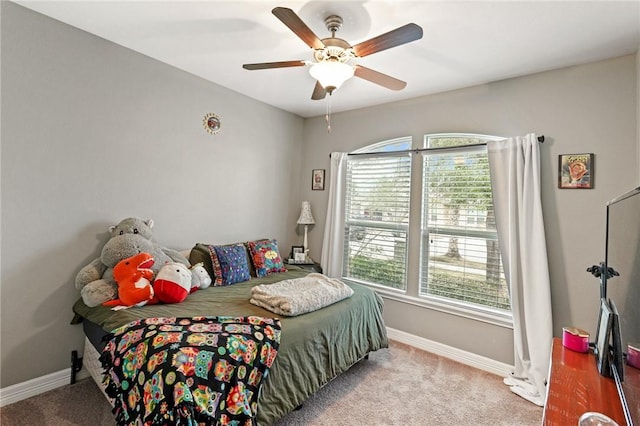 bedroom featuring light carpet, ceiling fan, and baseboards