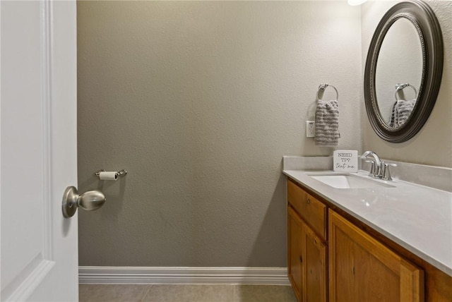 bathroom with tile patterned floors, baseboards, and vanity