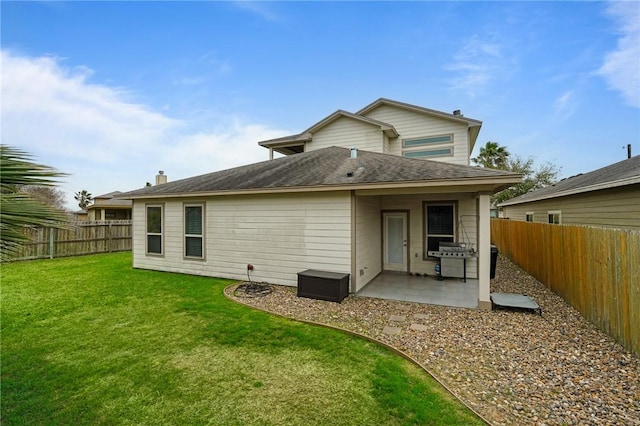 back of house with a yard, a fenced backyard, and a patio