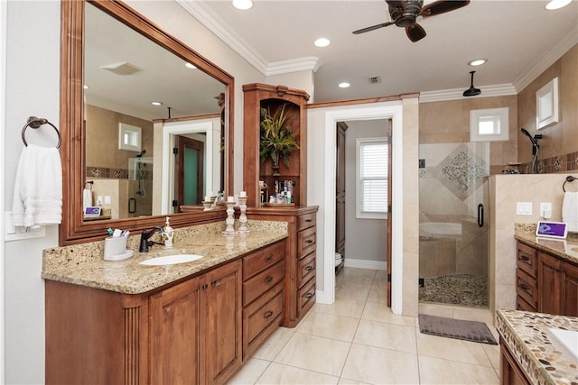 bathroom with vanity, a shower stall, toilet, and crown molding