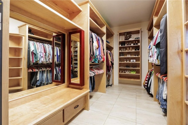 spacious closet with light tile patterned floors