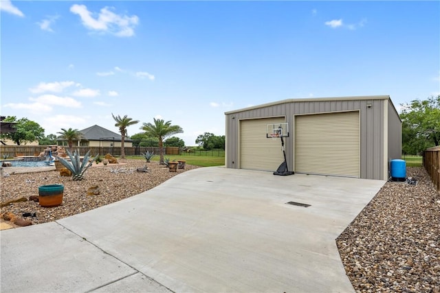 detached garage featuring fence