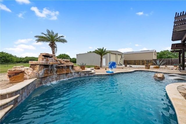 view of pool with a fenced in pool, an outbuilding, and fence