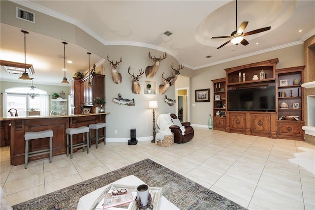 living room featuring ceiling fan with notable chandelier, light tile patterned flooring, visible vents, and crown molding