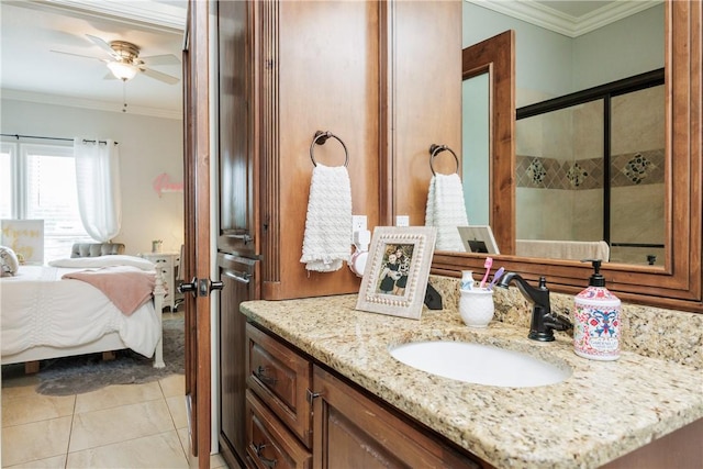 ensuite bathroom with tile patterned floors, crown molding, vanity, and ensuite bathroom