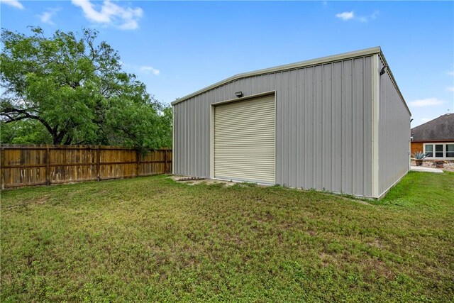 view of outdoor structure featuring an outbuilding and fence