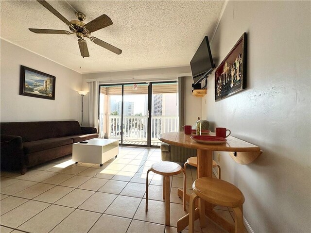 3938 Surfside Unit 3337, Corpus Christi, TX 78402 - living room featuring a textured ceiling, light tile patterned flooring, and ceiling fan