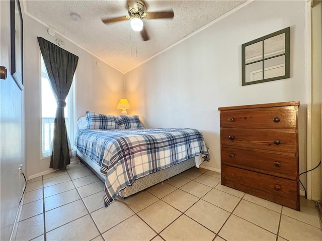 3938 Surfside Unit 3337, Corpus Christi, TX 78402 - bedroom with a textured ceiling, ornamental molding, light tile patterned flooring, ceiling fan, and lofted ceiling