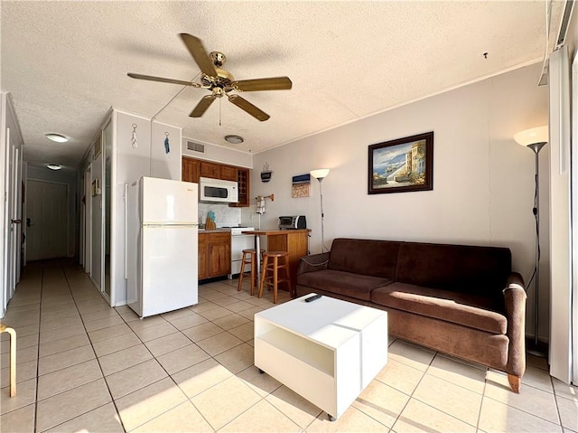 3938 Surfside Unit 3337, Corpus Christi, TX 78402 - living room with a textured ceiling, light tile patterned floors, and a ceiling fan