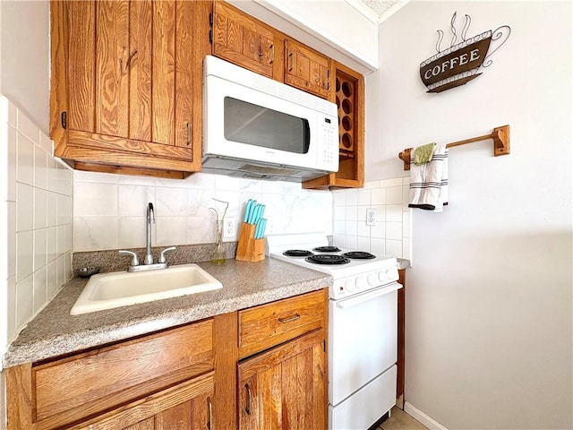 3938 Surfside Unit 3337, Corpus Christi, TX 78402 - kitchen with white appliances, brown cabinets, decorative backsplash, and light countertops