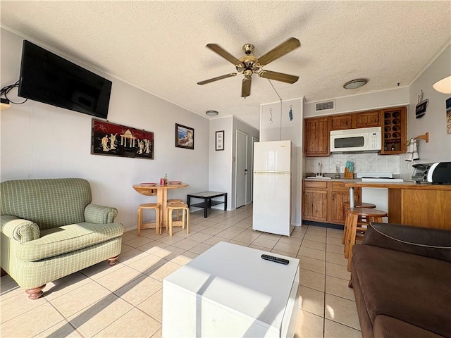 3938 Surfside Unit 3337, Corpus Christi, TX 78402 - living room with ceiling fan, light tile patterned flooring, and a textured ceiling