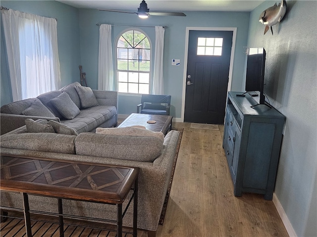 living room featuring light hardwood / wood-style floors and ceiling fan