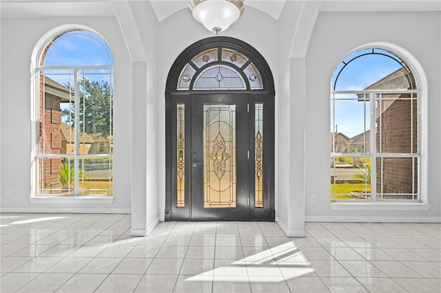 tiled foyer entrance with plenty of natural light and a towering ceiling