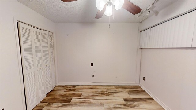 unfurnished bedroom with hardwood / wood-style flooring, ceiling fan, a textured ceiling, and a closet