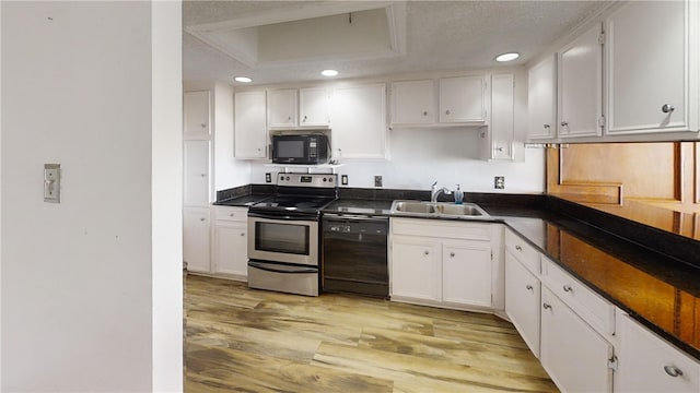 kitchen with white cabinetry, black appliances, and sink