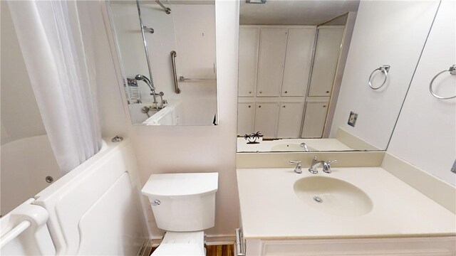 full bathroom featuring toilet, shower / bath combination with curtain, and sink