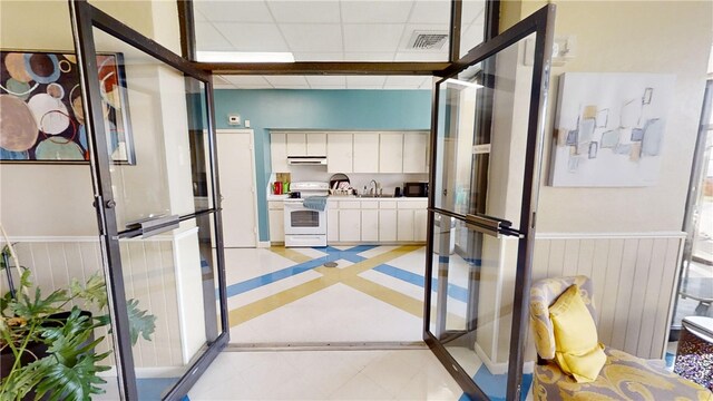 interior space featuring sink and a drop ceiling