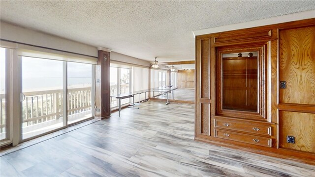 hallway with a textured ceiling and wooden walls