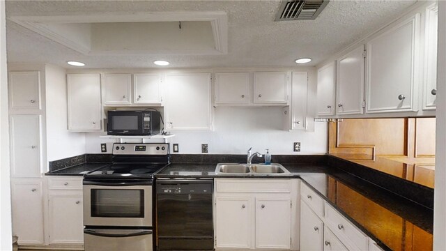 kitchen featuring black appliances, a textured ceiling, sink, a raised ceiling, and white cabinetry