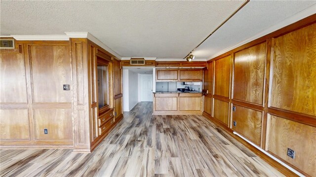 kitchen with hardwood / wood-style flooring, a textured ceiling, wooden walls, and rail lighting