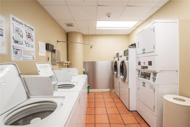 laundry area featuring light tile patterned flooring, separate washer and dryer, and stacked washing maching and dryer