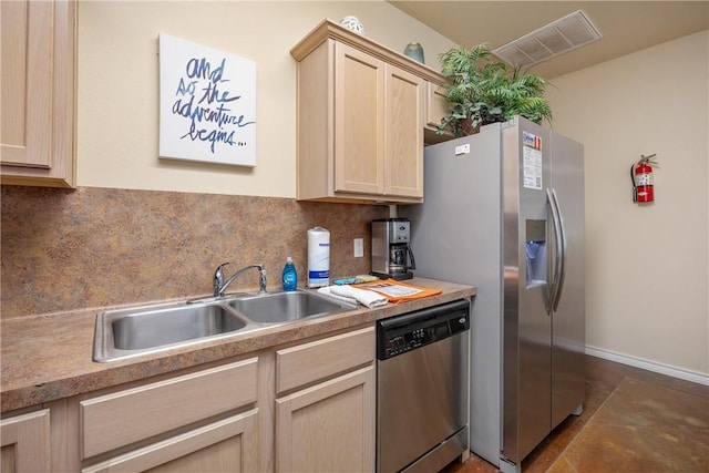 kitchen with backsplash, sink, light brown cabinets, and appliances with stainless steel finishes