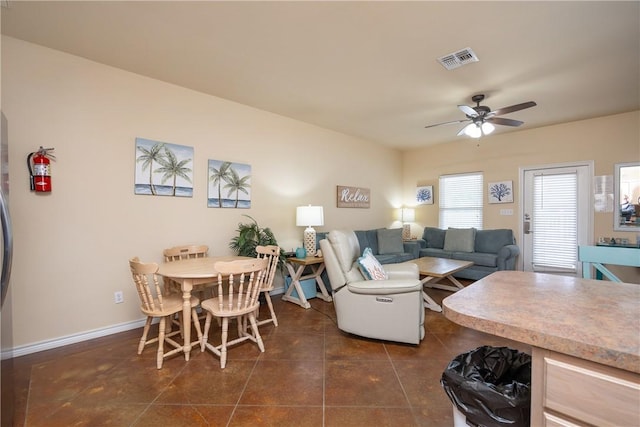 tiled dining space featuring ceiling fan