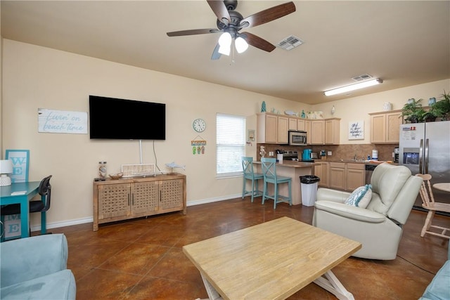 living room with dark tile patterned floors and ceiling fan