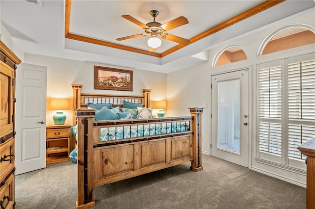 carpeted bedroom featuring ornamental molding, access to outside, ceiling fan, and a raised ceiling