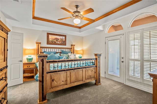15746 Cuttysark St, Corpus Christi, TX 78418 - bedroom featuring dark colored carpet, access to outside, a tray ceiling, and a ceiling fan