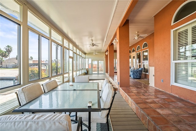 sunroom with a wealth of natural light and ceiling fan