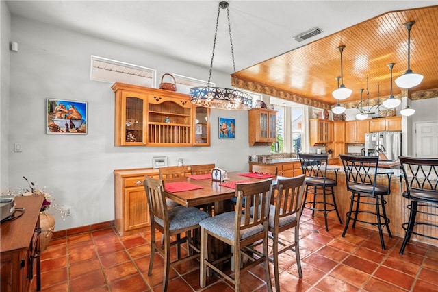 dining space with wood ceiling