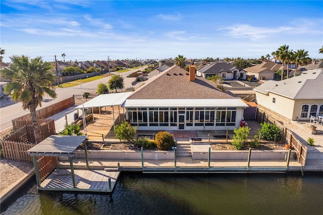 15746 Cuttysark St, Corpus Christi, TX 78418 - rear view of house featuring a residential view, a water view, and a chimney