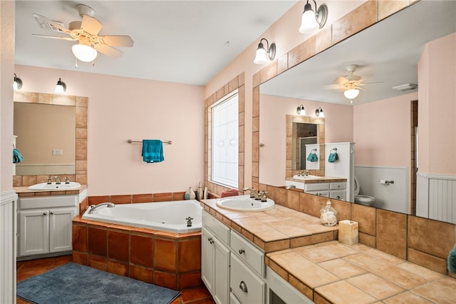 bathroom with ceiling fan, vanity, and toilet