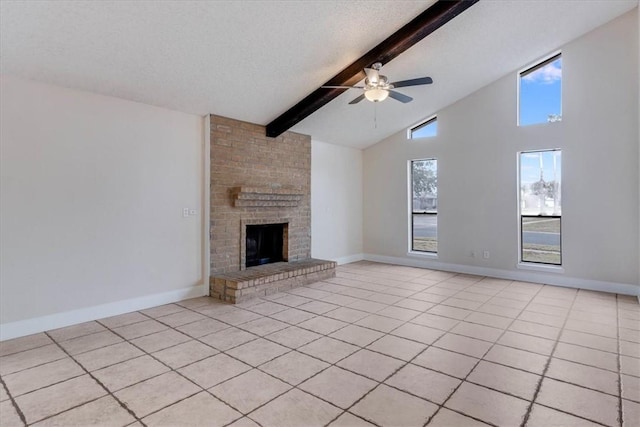 unfurnished living room featuring a textured ceiling, beamed ceiling, a fireplace, and plenty of natural light