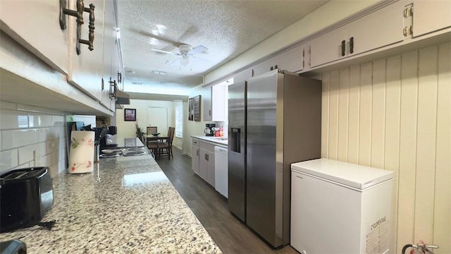 134 Daniel Moore St, Portland, TX 78374 - kitchen with refrigerator, stainless steel fridge with ice dispenser, light countertops, dishwasher, and a textured ceiling