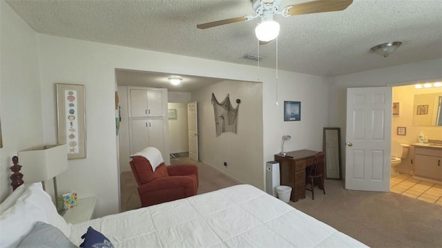 134 Daniel Moore St, Portland, TX 78374 - bedroom with light carpet, a textured ceiling, and connected bathroom