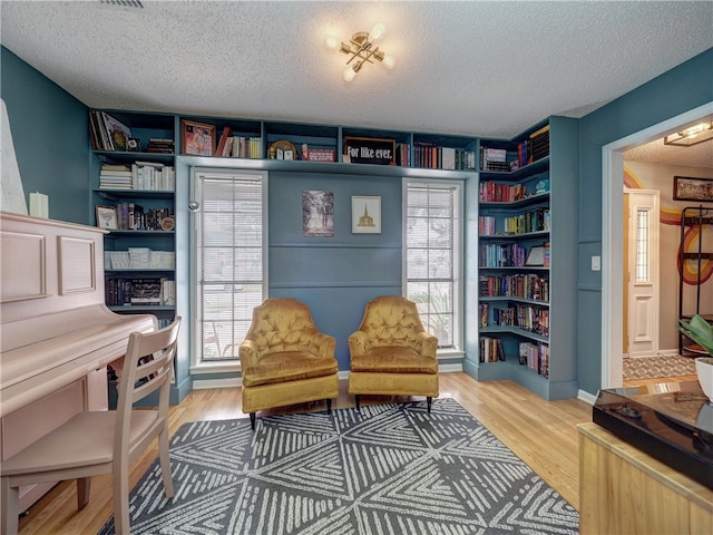 sitting room featuring hardwood / wood-style floors and a textured ceiling