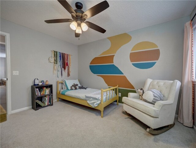 bedroom with carpet flooring, a textured ceiling, and ceiling fan