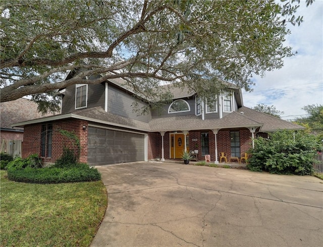 view of front of property featuring a garage and a front lawn