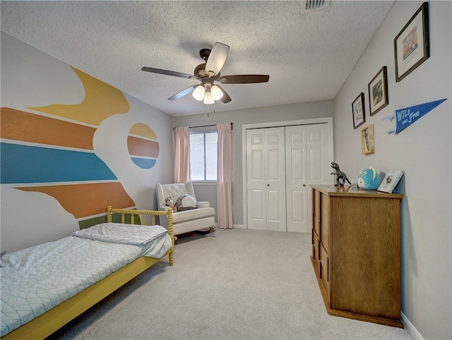 sitting room featuring a textured ceiling, light carpet, and ceiling fan